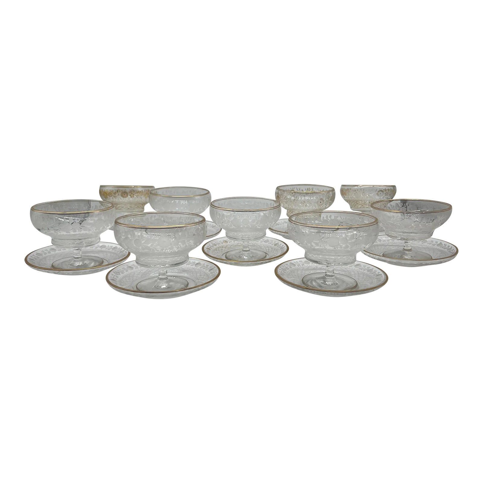 18 Pc, Antique Foliate & Gilt Acid Etched Champagne Coupe & Under Plate Set: French, likely 19th to early 20th century. A grouping of 18 foliate acid etched champagne coupes & under plates or shrimp cocktail glasses. A service for 9 place settings, each having a gilt rim to