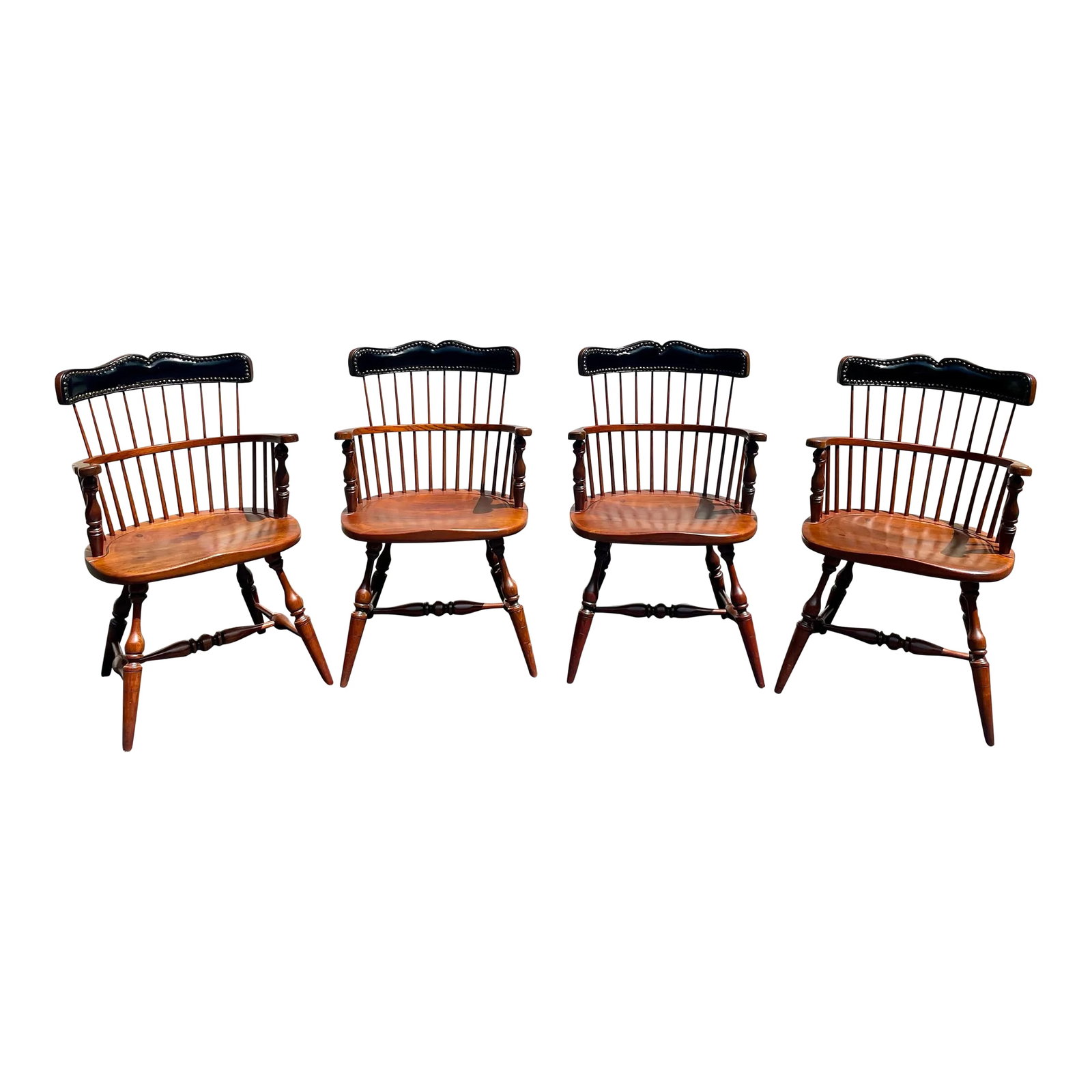 Frederick Duckloe & Bros. Windsor Style Captains Chairs With Leather Nail Head Detailed Backs- Set o: Offered is a set of four Frederick Duckloe & Brothers Windsor style Captain's chairs. They have a high back with a leather back rest and nail head detail. As with all Duckloe furniture they are made o