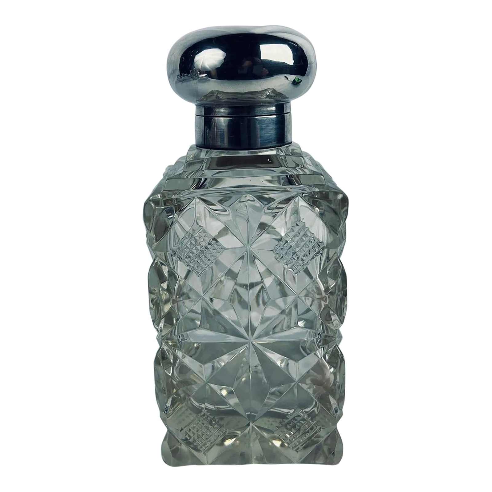 English Sterling Silver & Cut Glass Vanity Jar, Early 20th Century: This elegant vanity jar, crafted in the early 20th century, exemplifies the refined aesthetics and exceptional craftsmanship of English decorative arts. The jar features a finely cut glass body, adorn