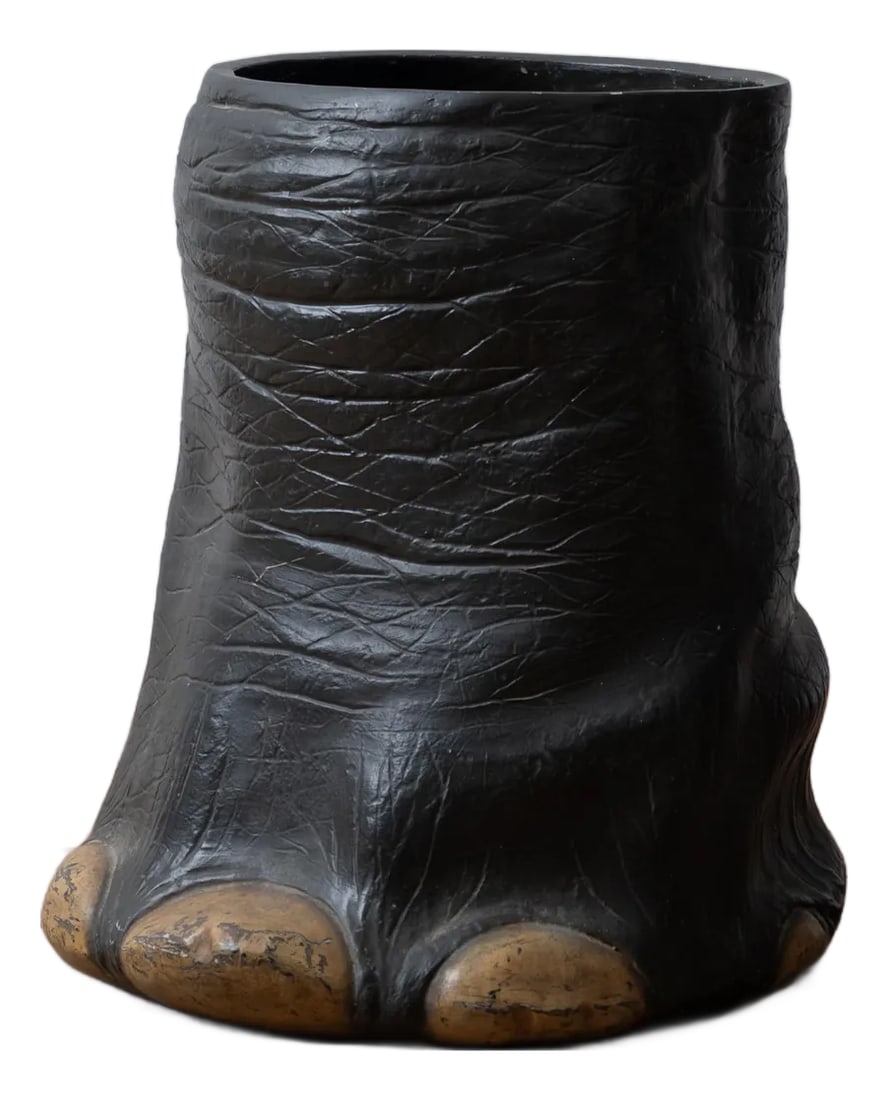 Faux Elephants Foot Umbrella Stand: A fiberglass faux elephants foot umbrella stand or waste basket, mid-20th century. 14 inches wide by 16 inches deep by 16 1/2 inches tall Condition: Alterations: Original Condition Unaltered