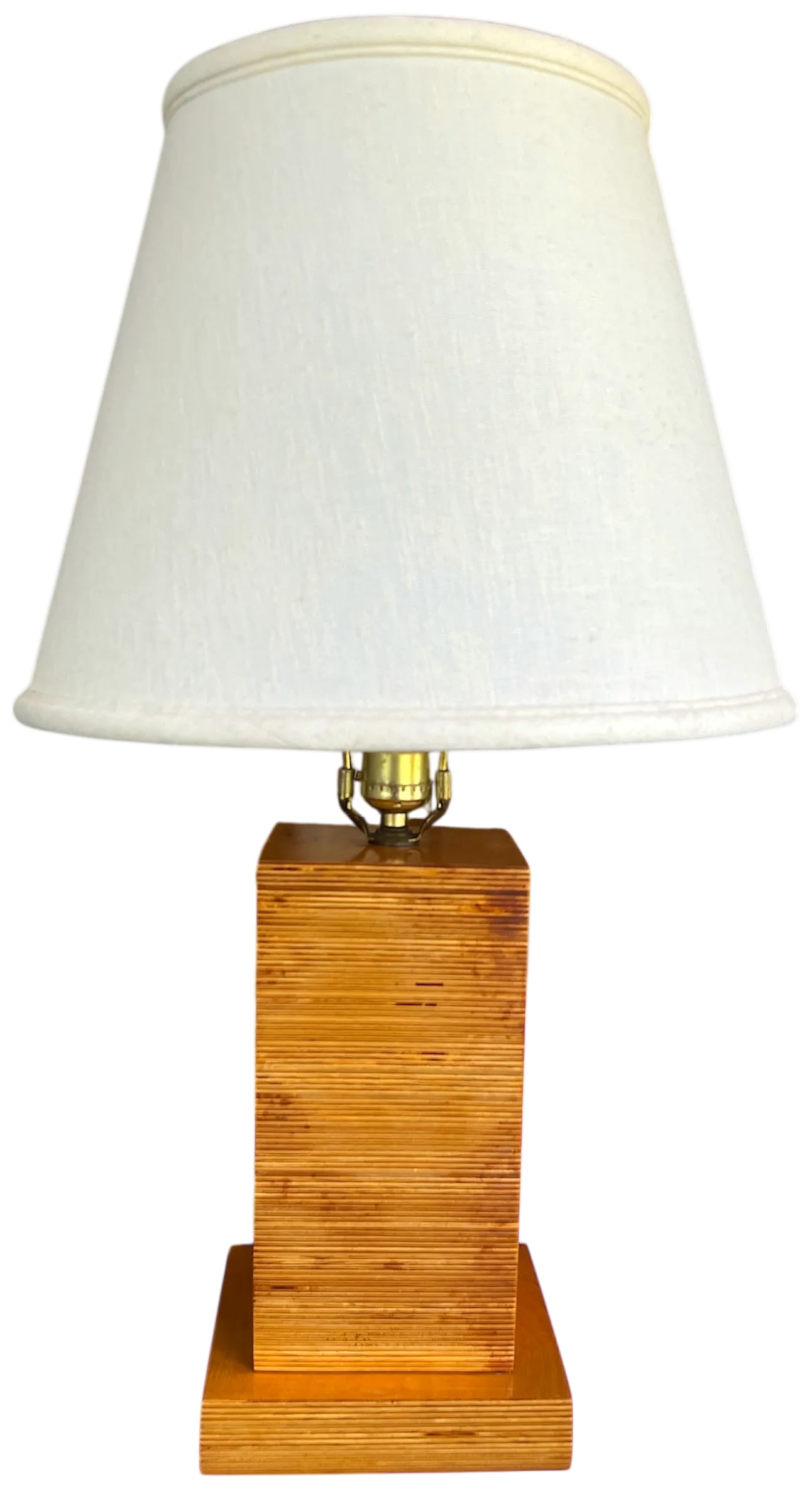 1970s Craftsman-Made Stacked and Laminated Plywood Table Lamp With Linen Shade: 1970s craftsman-made stacked plywood laminate table lamp. The lamp showcases the natural beauty of layered wood grain in a clean, geometric silhouette. Its minimalist, blocky form nods to both Brutali
