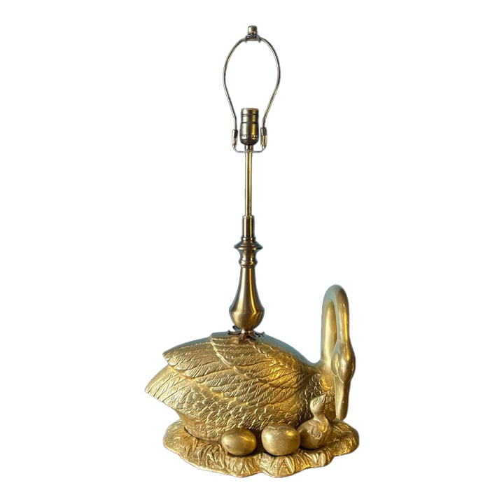 Mid-Century Brass Swan Signets Brass Table Lamp: This vintage brass lamp masterfully captures the grace and elegance of nature, featuring a majestic swan at the heart of its design. The swan, with a posture both regal and tender, cradles her newly