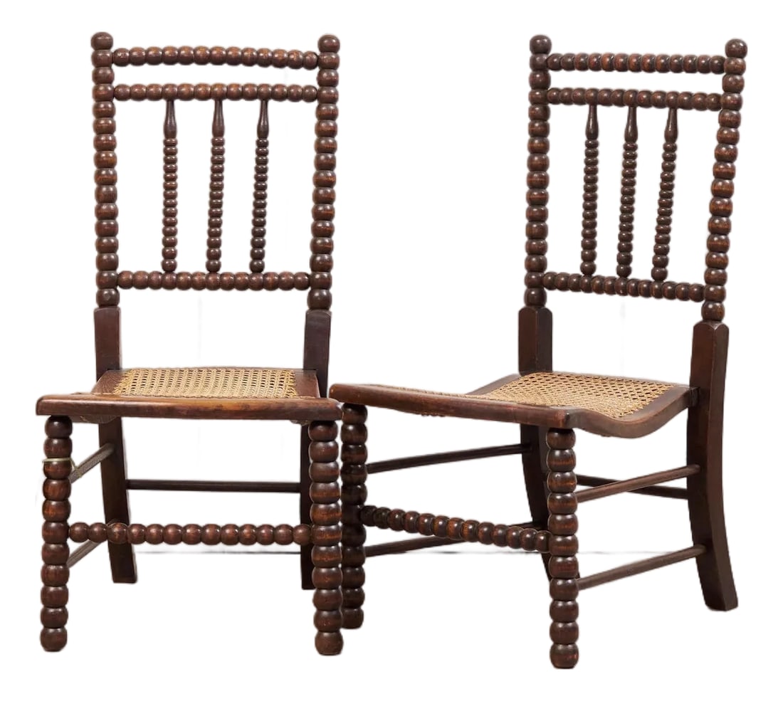 Late 19th Century Pair of Victorian Bobbin Turned Children Chairs: A rare PAIR of Antique Bobbin Children's Chairs (c. 1890). Incredible patina and warm oak coloring on this with perfect conditioned hand caning. A lovely way to add a touch of character and depth in a