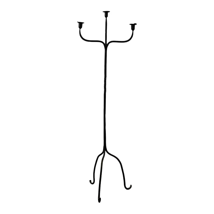 Antique Tall Wrought Iron Floor Candelabra: The tall, black iron candelabra features three arms supporting taper candles, leading to a twisted central shaft, raised on tripod legs ending with curved feet. 17" W x 15.5" D x 52" H Condition: Alte