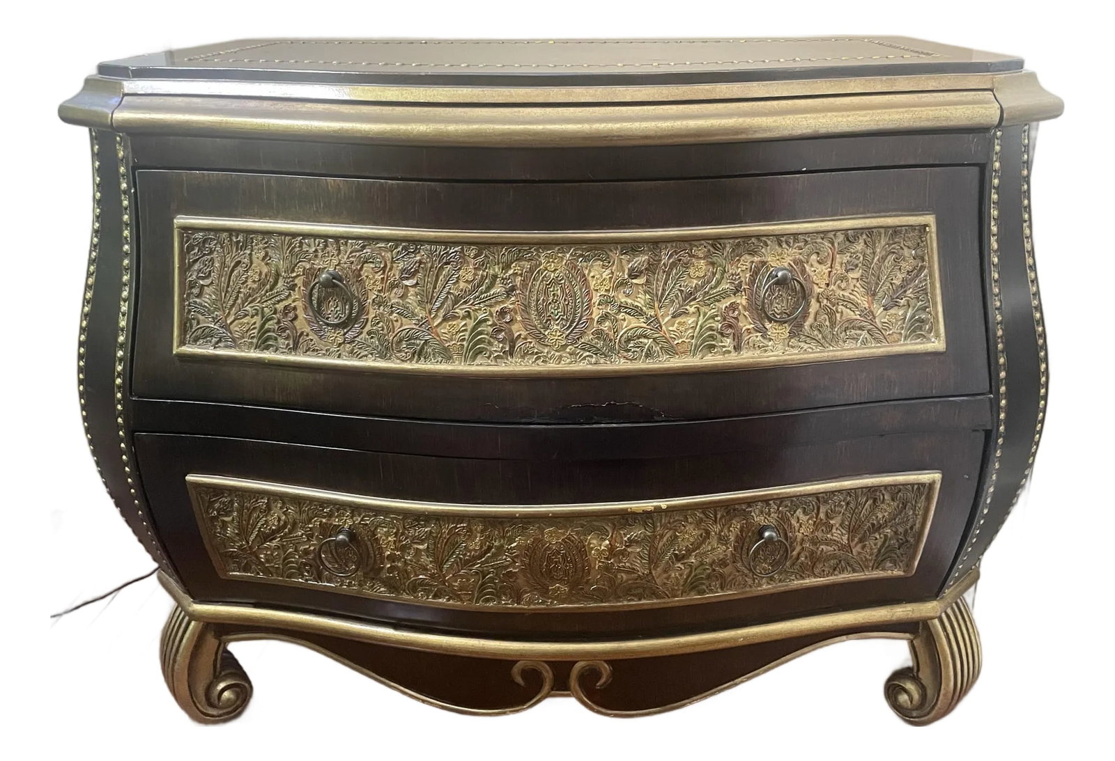 Late 20th Century Bombe Chest With Embossed Floral Panels, Gold Detail - Hollywood Regency Style: Striking bombe-form two-drawer chest with ebonized finish, gold-leaf trim, nailhead detailing, and richly embossed floral panels in green, rust, and gold across both drawer fronts. Scrolled gold feet 