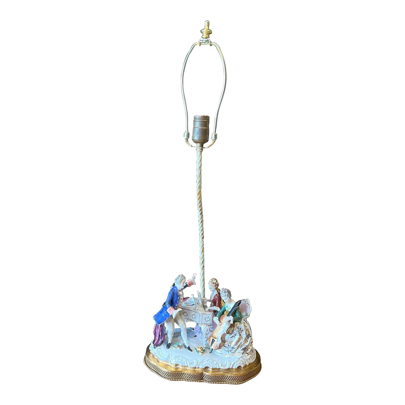 Vintage Porcelain Musician Trio Figural Table Lamp L. C. Co, Japan.: This lamp depicts a trio of musicians wearing 18th Century period clothing. A young man dressed in a blue overcoat, yellow vest, gold trimmed ascot and white breeches stands to left, in front of a pia