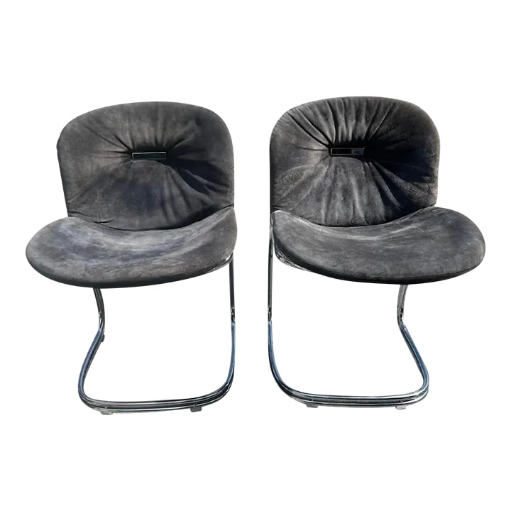 Italian Suede Sabrina Dining Chairs by Rima Rinaldi: The Sabrina chairs were designed by Rima Rinaldi in Italy circa 1970. The chairs feature chrome tubular steel frames with wire backs and blue faded suede upholstery. Condition: Alterations: Original C