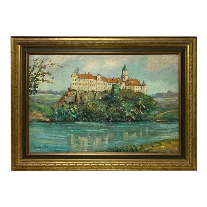 Framed French Castle Oil on Canvas Painting Signed Blanchard: A framed oil on canvas painting that features a red roofed white castle on a hill overlooking a cerulean blue river by French artist, Antoine Blanchard. The castle is visible reflected in the water, a