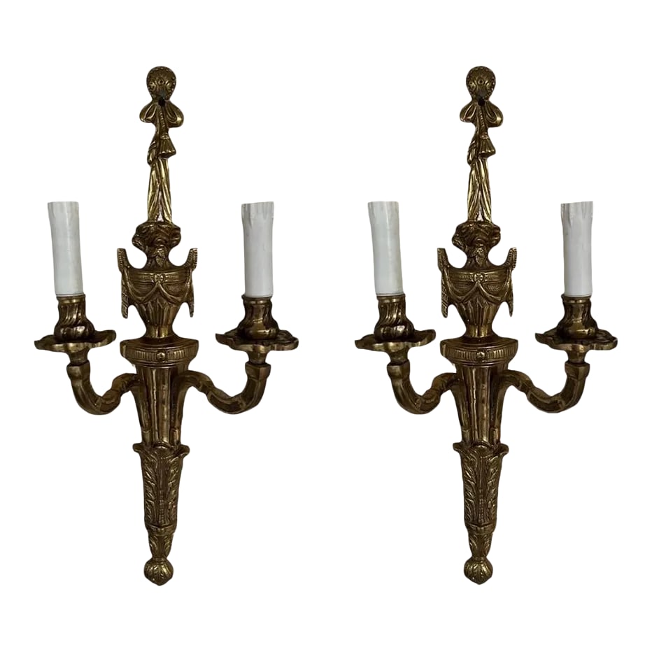 Pair, Vintage Italian Gilt Bronze Two-Light Wall Sconce: Italian, 20th century. A pair of gilt bronze wall sconces with traditional urn form body, draped rope header and two arms with faux wax candle covers. Marked to verso "Made In Italy". Fully functional