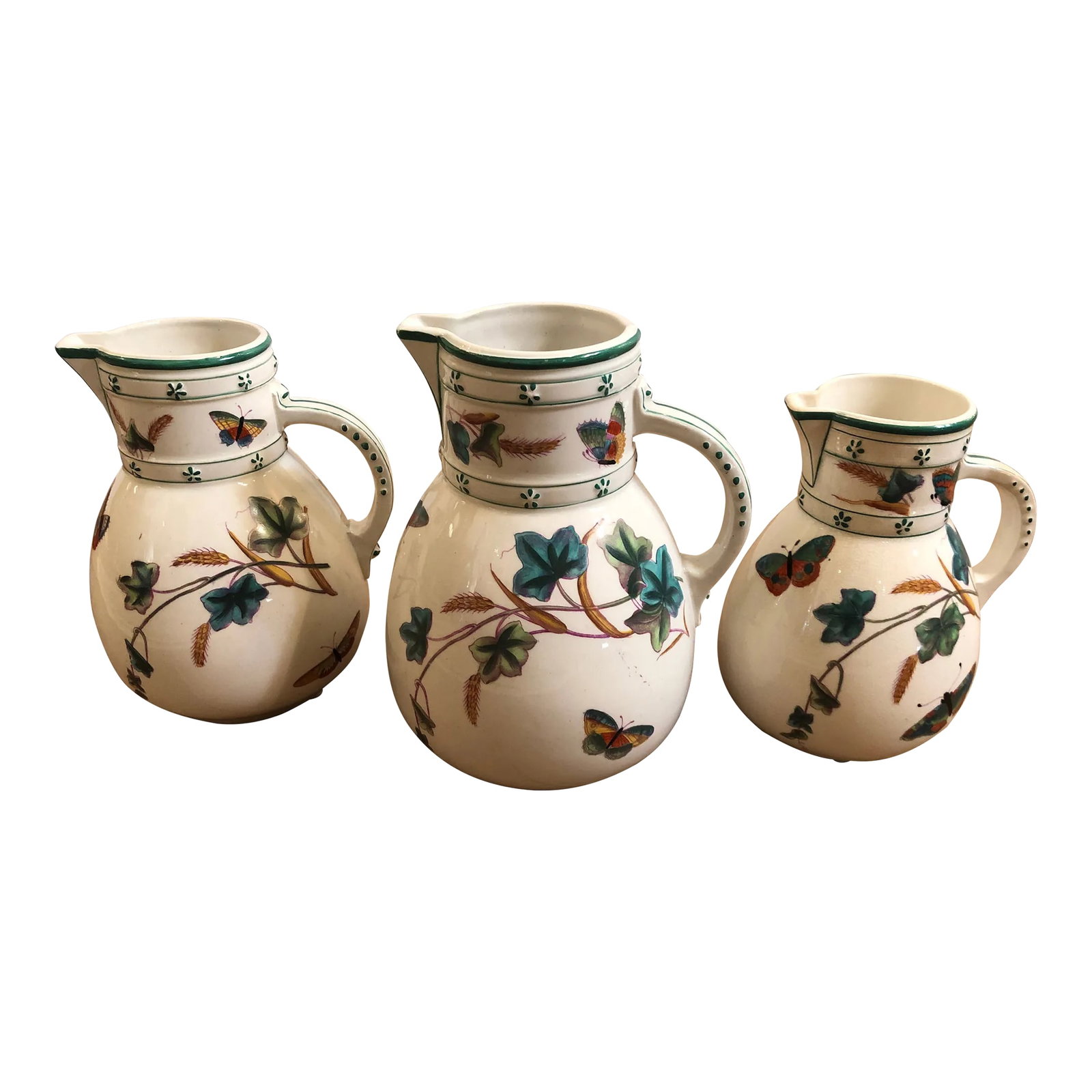 Antique English Porcelain Pitchers -Set of 3: Lovely collection of 3 antique English porcelain pitchers in varying sizes having gorgeous butterflies and flowers handpainted against a white background. 7.5" h, 7" h and 6.5" h Condition: