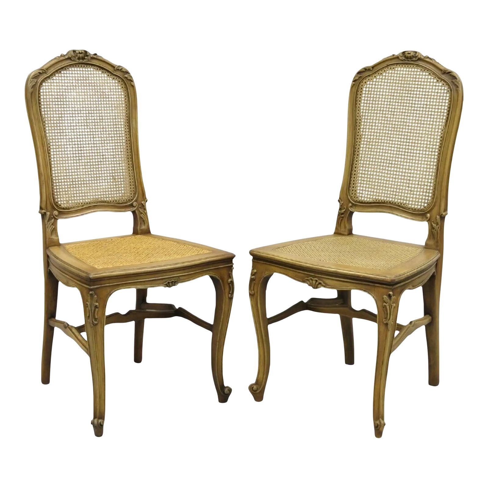 Early 20th Century Antique French Provincial Louis XV Style Carved Walnut Cane Dining Chair - Pair: Cane back and seat, carved stretcher, solid wood construction, beautiful wood grain, finely carved details, cabriole legs, very nice antique item. Slight variation in color and carvings between chairs