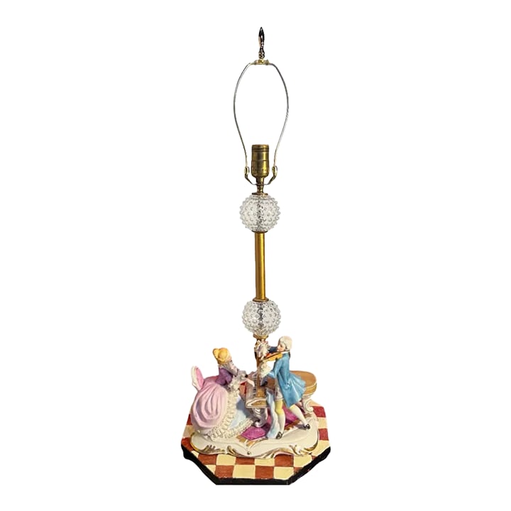 Vintage Porcelain Figural Table Lamp: Musician Couple: This exquisite porcelain figurine, crafted in Japan for Art Mark, beautifully captures a scene of 18th-century elegance. It features a woman gracefully playing the piano while a man accompanies her