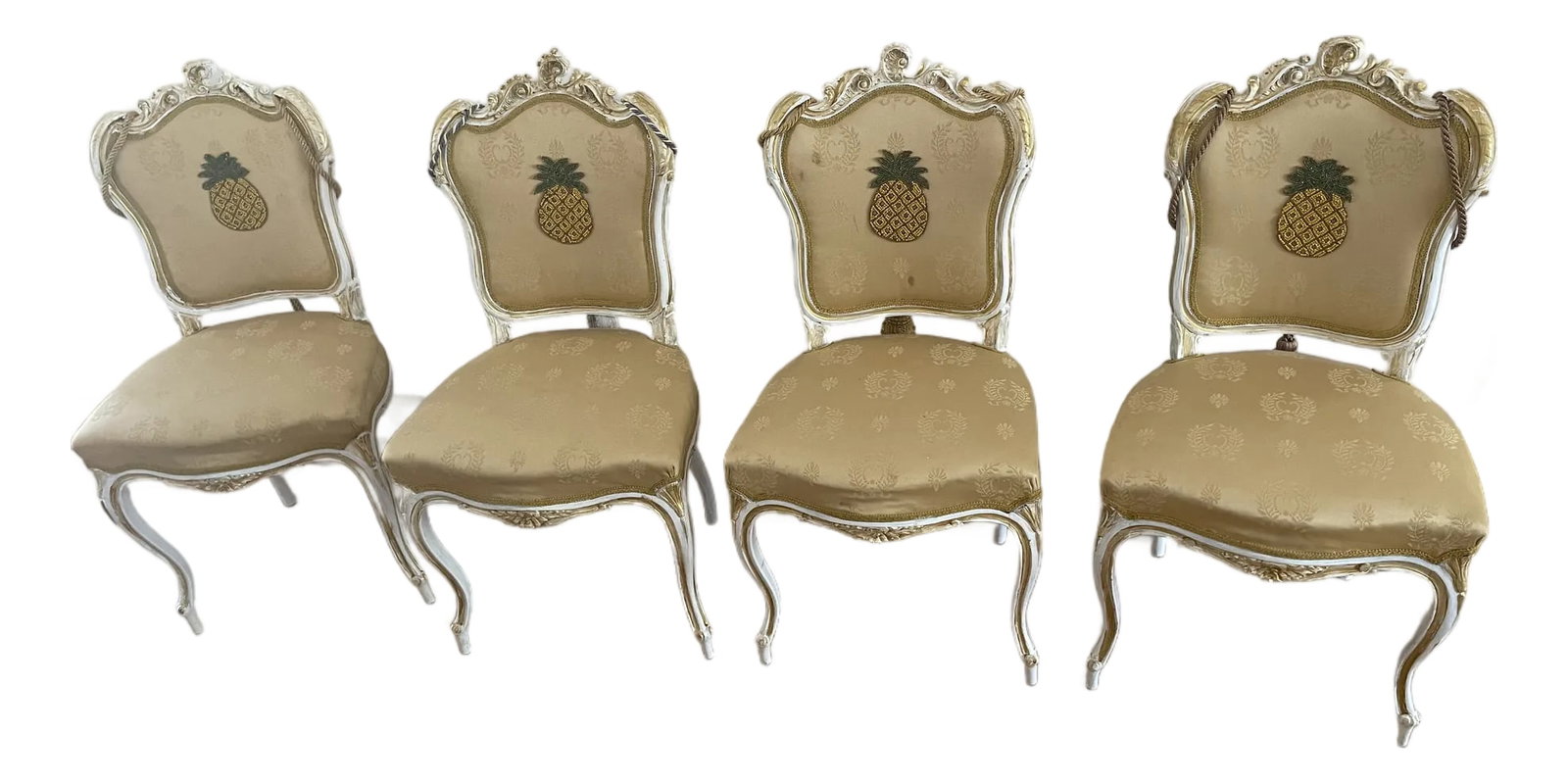 4s Antique French 19 Th C Louis XVI Chairs in MacKenzie Childs Style: 19 th c French antique handcarved walnut Louis XVI style chairs, painted white with gold wash, decorated with beaded pine apples and large tassels in the back. In Mackenzie Childs style. Condition: Al