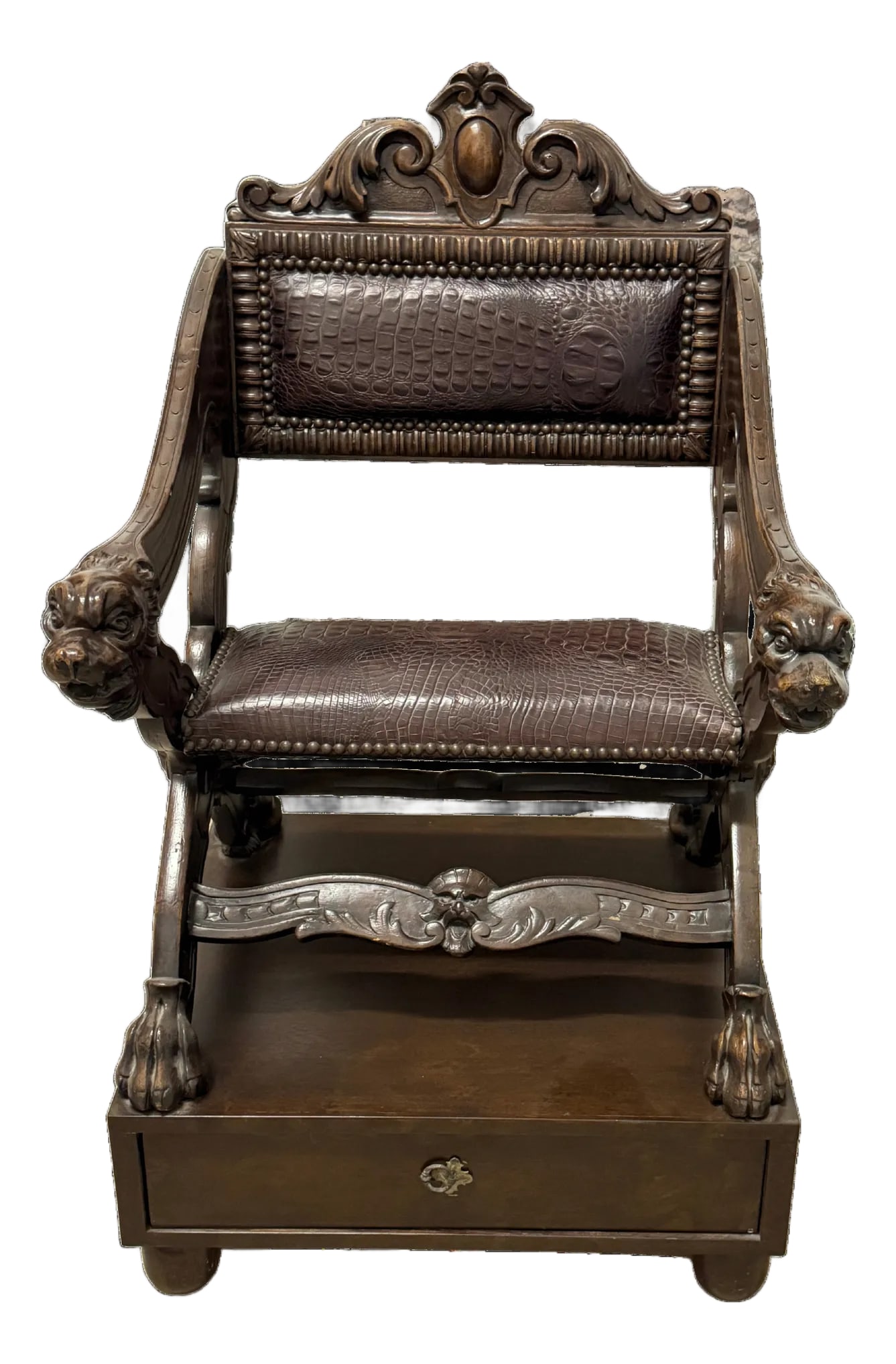 Early 20th Century Carved Dog-Head Savonarola Chair: Renaissance Revival-style Savonarola chair with carved dog-head arm terminals, scrolled cresting, and paw feet. The X-form frame is mounted on a later fitted drawer base with carved apron and central 