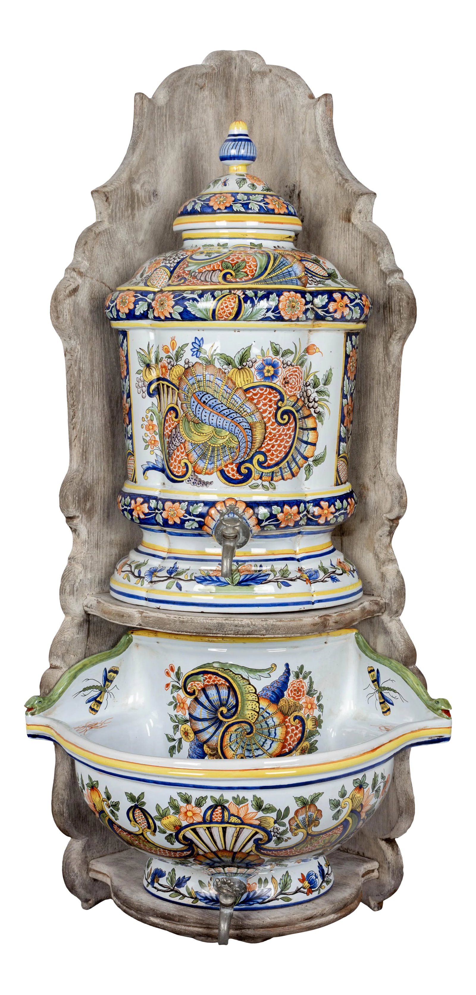 French Desvres Faience Lavabo: A French Desvres faience Louis XV style lavabo with traditional colorful hand painted decoration. The lidded urn and large deep basin rest on a whitewashed chestnut wall mounted corner shelf. Each wit