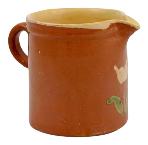 19th Century French Redware Pitcher With White Flower Decor: French redware pitcher from the 19th century, with white flowers. We have two available.. Created in France during the 19th century, each of these pitchers features a cylindrical body, adorned with a