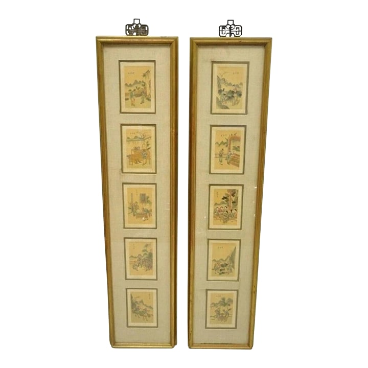 Vintage Asian Oriental Framed Art Prints With Narrow Gold Frames - A Pair: Vintage Asian Oriental Framed Art Prints with Narrow Gold Frames - a Pair. Item features wood frame with distressed finish, brass decorative hooks, (5) framed prints per piece of various village scene