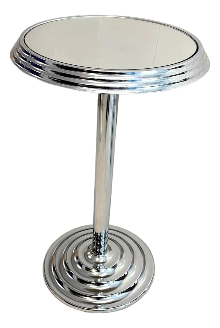 1980s Art Deco Chrome and Mirrored Glass Accent Table: Art Deco-style accent table features a chrome frame with mirrored glass surfaces, commonly used as a smoker's stand or side table. It stands 25" tall with a 14" diameter, showcasing sleek geometric li