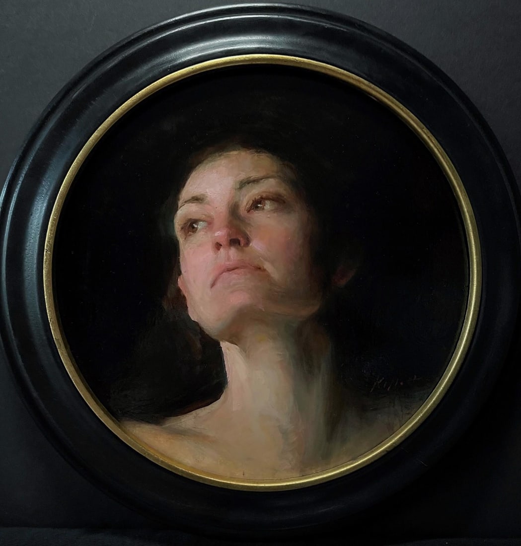 Lingering by Karen Offutt | Oil Painting of a woman with a contemplative expression: This circular oil painting presents a contemplative figure, gazing upward with a sense of introspection. The soft, muted palette enhances the emotional depth, while the delicate handling of light and