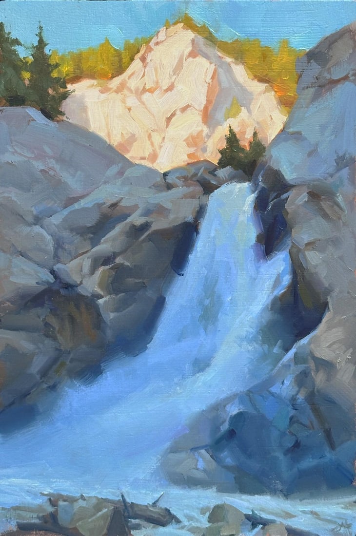 Emanation by Judd Mercer | Oil on Wood Panel Waterfall cascading over rocks with trees in background: This oil painting on wood panel captures a serene waterfall cascading over rugged rocks, framed by lush trees and distant mountains. The interplay of light and shadow creates a tranquil atmosphere, wh