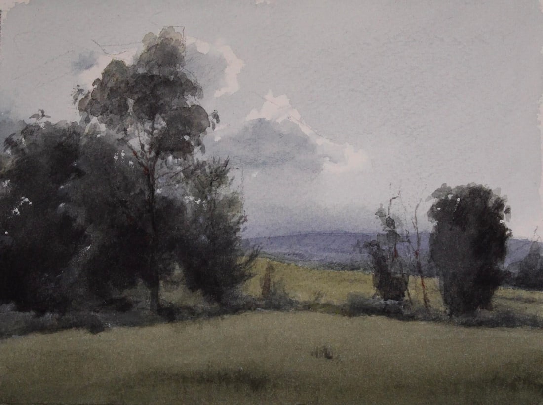 Summer Greens by Mo Myra | Watercolor on Paper Landscape with Trees and Fields: In "Summer Greens," soft washes of watercolor create a serene landscape, where lush greenery meets a distant horizon under a subtly clouded sky. The delicate interplay of light and shadow evokes a