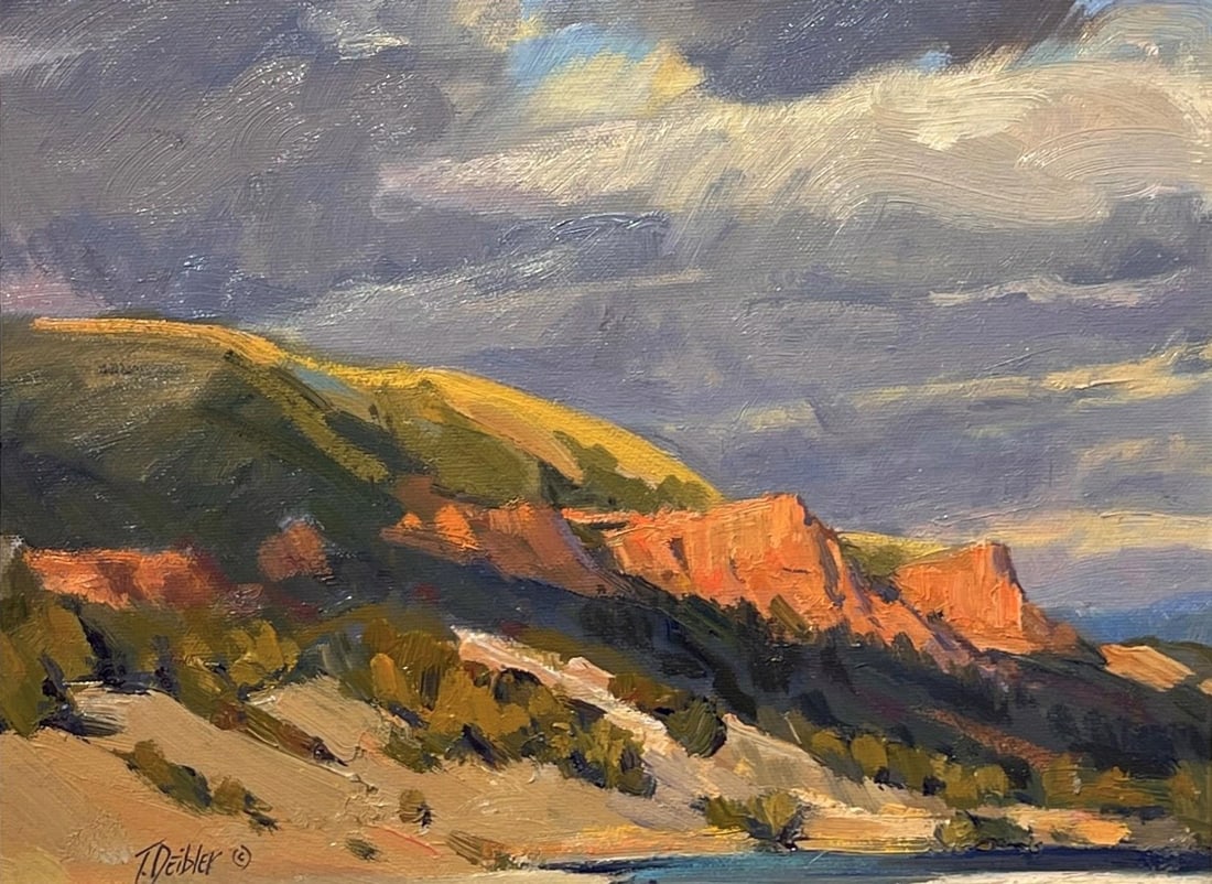 Red Cliffs by Tim Deibler | Oil Painting of red cliffs under a cloudy sky: The painting captures a dramatic landscape of red cliffs under a moody sky, where the interplay of light and shadow enhances the rugged terrain. Rich, warm hues contrast with cooler tones in the