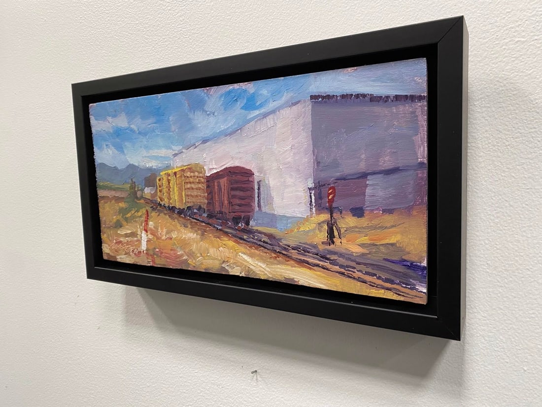 Trackside 2 by Delton Demarest | Oil on Board Painting of train cars near a building - 4