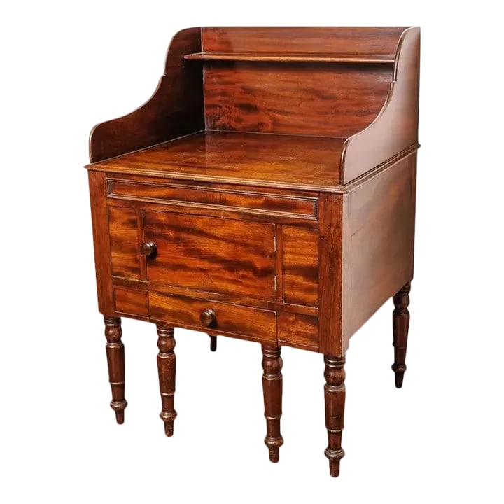 1840's English Mahogany Bedside Stand: Mid/Early 19th century English mahogany bedside stand of rare large size with it's porcelain bidet. It has a large flat surface and shelf for the wash bowl and pitcher set. The lower part of the cabin