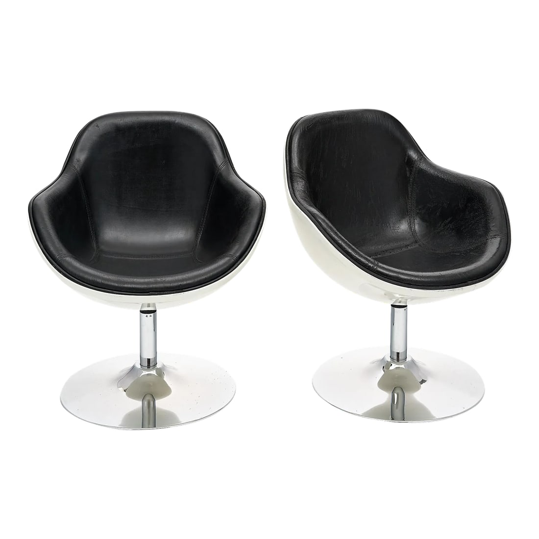 Pair of Vintage French Armchairs: Pair of armchairs in the French modernist style. The vintage armchairs feature an ivory polyurethane shell with an original black vinyl upholstery inside. The armchairs swivel on a chromed steel cente