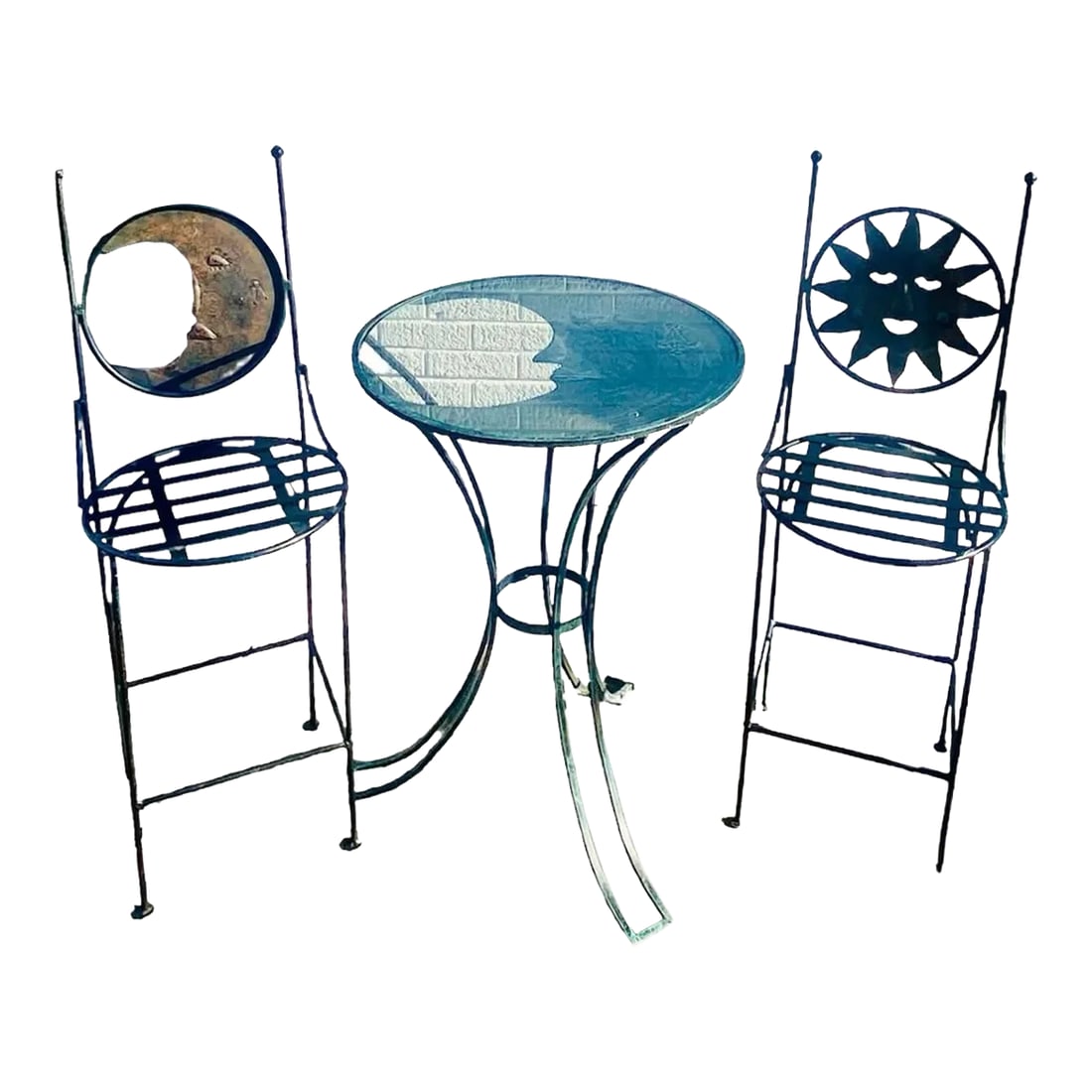 1990s Art Deco Mexican Wrought Iron Celestial Moon and Sun Table & 2 Barstools: An exquisite set of two Art Deco wrought iron indoor or patio bar chairs and round high top table. The circular shaped back of one chair is carved to represent the sun and the other one is the moon. T