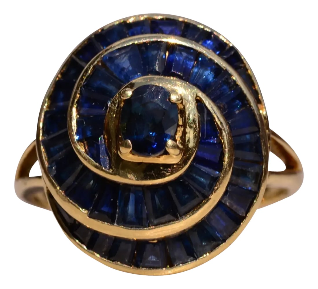 The Willare: Vintage Spiral Sapphire and Yellow Gold Cocktail Ring: The Willare: Vintage Spiral Sapphire and Yellow Gold Cocktail Ring. Admire this impressive cocktail ring set with 2.50 total carats of blue sapphires set in a Fibonacci spiral design. At the heart of