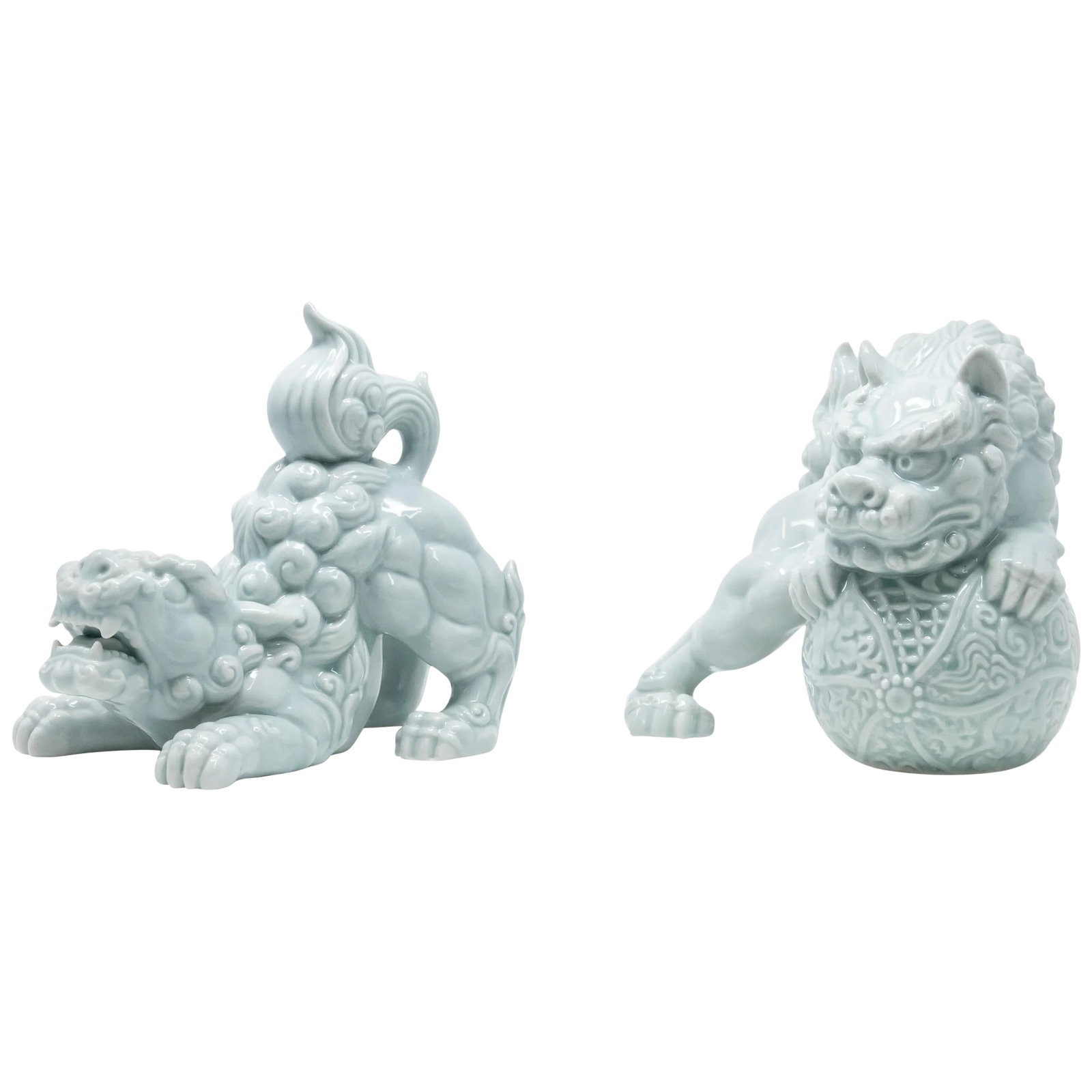 Andrea by Sadek Celadon Foo Dog Figurines - a Pair: Offering this beautiful pair of Andrea by Sadek Celadon Foo Dogs. Gorgeous light turquoise color these are sure to stand out wherever you choose to put them. One is in a downward dog position that is