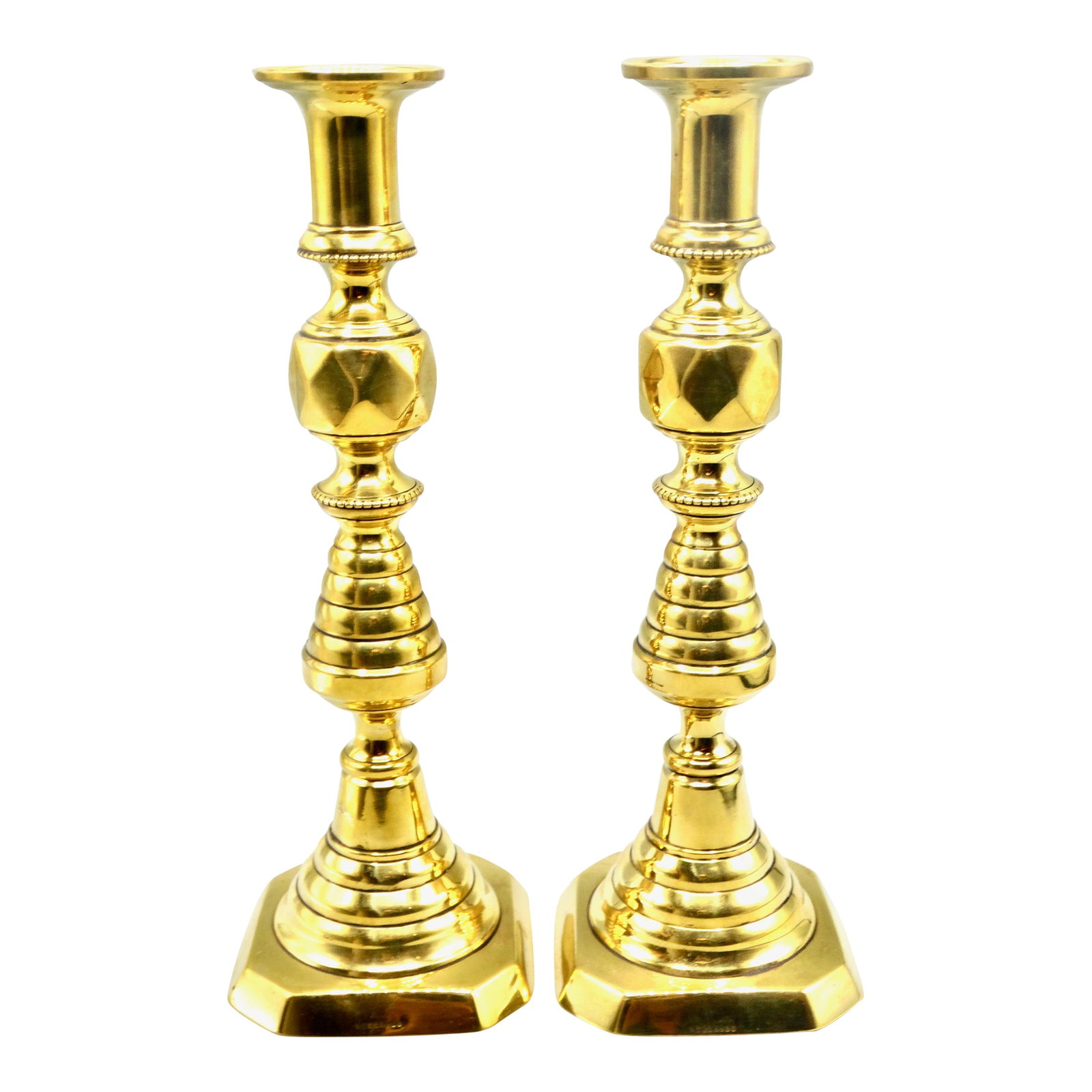 Antique English Brass Push-Up Beehive Candlesticks, a Pair: A fine pair of antique 19th-Century English push-up brass candlesticks with an elegant inverted beehive form. They retain the original ejector push-up rods in the base. They are a quality pair of stic