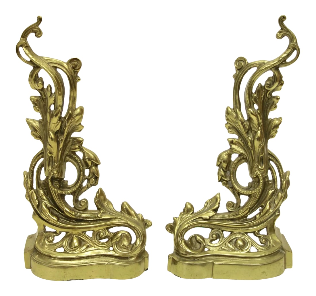19th Century French Rococo-Style Brass Andirons, Pair: Lovely pair of cast brass andirons in the French Rococo style. Features a classic asymmetrical leaf and volute motif throughout. Nice lacquered finish. Very good vintage condition; minor patina on the
