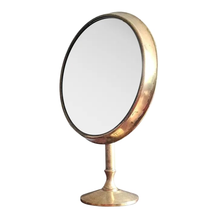 1940s Italian Brass Table Mirror: Italian brass beveled round mirror in style of Ico Paricsi. Adjustable position great for the vanity table or jewelry store. Base is 7.2 diameter. Condition: Alterations: Unknown Imperfections: Some