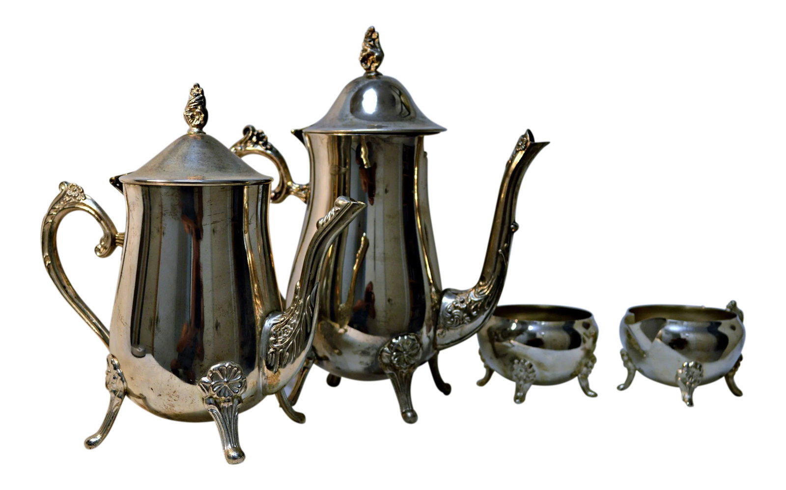 Silver Plated Coffee & Tea Set - 4 Pieces: English Traditional Design Footed Tea & Coffee Set, Includes 26-oz. teapot, 30-oz. coffee pot ( both of them with articulated lid), creamer and open sugar bowl. Hand wash only. The set is in