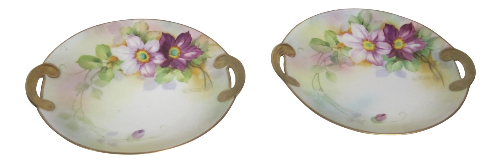 Nippon Floral Plates - A Pair: The porcelain plates have a hand painted floral pattern in colors of rose, purple and green with gold trim. They are signed by the artist, W. Ross. Condition: Condition Notes: Excellent - Minor wear c