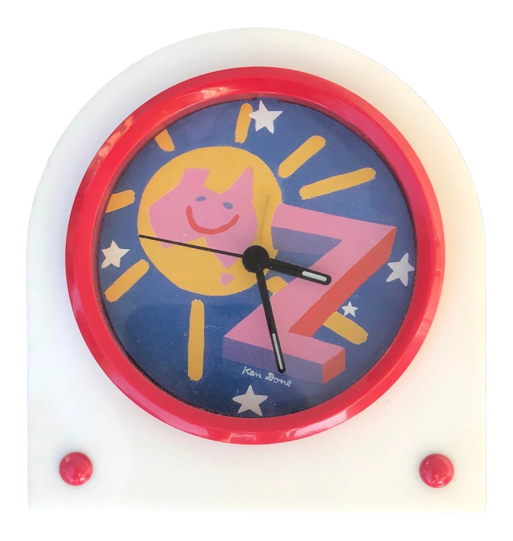 1980s Ken Done Bedside Alarm Clock: Postmodern battery operated alarm clock featuring art by Ken Done. Kenneth Stephen "Ken" Done AM is an Australian artist best known for his design work. Although his simple, brightly coloured images