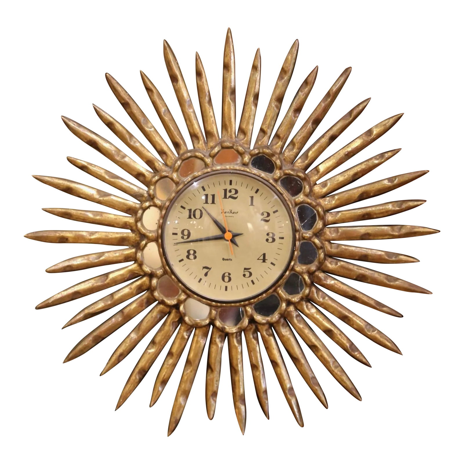 Mid 20th Century Mid-Century Spanish Carved Giltwood Sunburst Wall Clock With Mirrored Insets: Add a touch of elegance to your home with this striking gilt wood sunburst clock, hand-carved in Spain circa 1970. This vintage piece features a central circular dial, surrounded by mirrored insets an