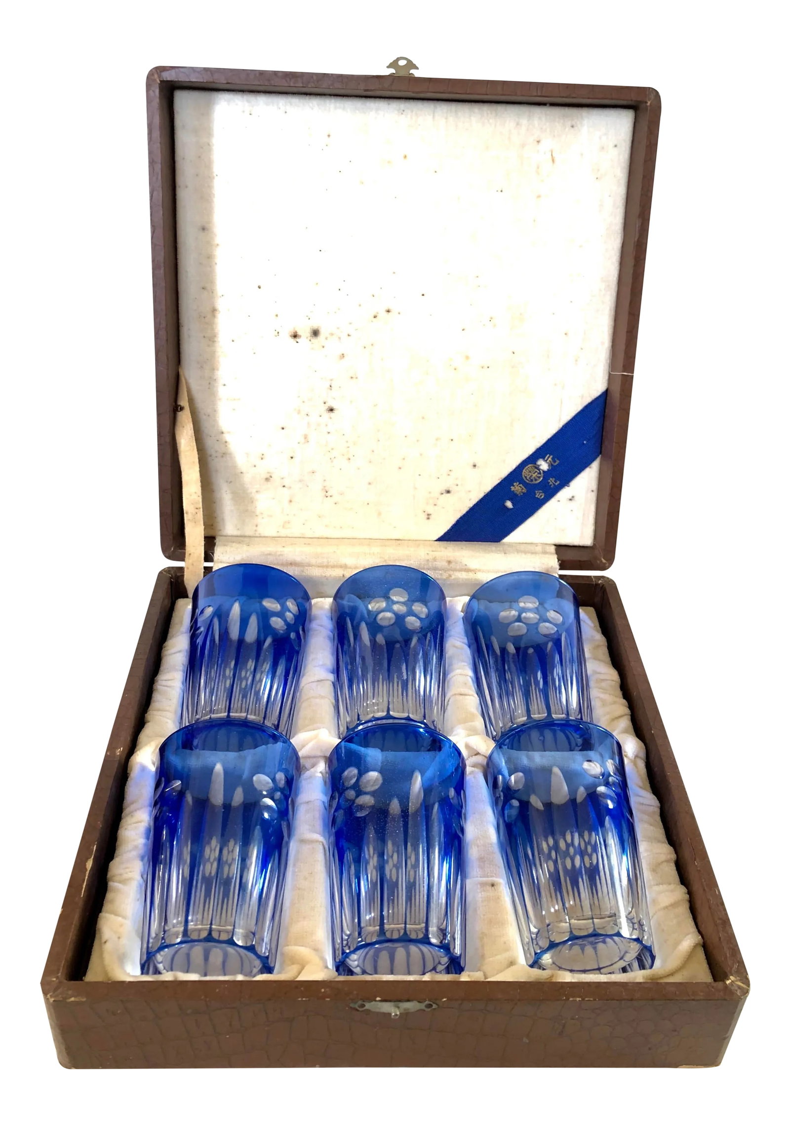 Blue Cut Glass Beverage Set in Box, Set of 6: Early 20th century Japanese cut glass set in presentation box. Beautiful blue and transparent pattern of fluting from the base up to stylized floral motif. Storage box measures 9.5" square x 2.75" H.
