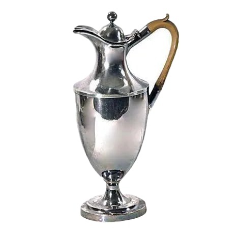 Antique Regency Style Silverplated Pitcher: Antique English Regency style silver-plate lidded pitcher with a wooden handle. Condition: some surface wear. Materials: silverplate/wood. Marked "S" on the underside. Circa 1900-1910. Condition: