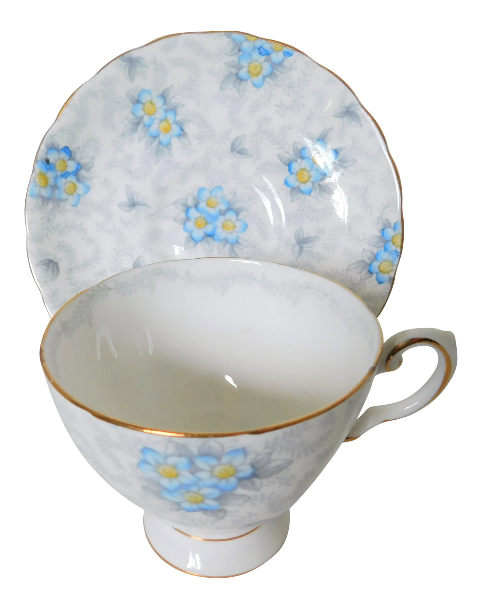 1950s Tuscan Porcelain Chintz Forget-Me-Not Teacup and Saucer Set- 2 Pieces: This beautifully-shaped Tuscan Fine English Bone China porcelain chintz teacup and saucer is a unique combination of soft gray all-over leaves and little blue forget-me-not flowers on a white