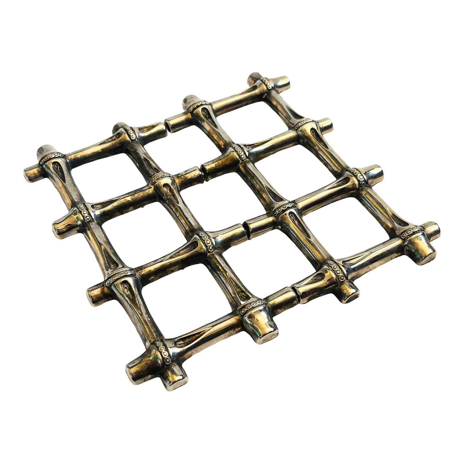 Expanding Silver Bamboo Trivet: A vintage expanding trivet made out of silver toned metal with a bamboo design. Measures 7" Square x 1"H and expands to 10.25"W Condition: Alterations: Original Condition Unaltered Imperfections: