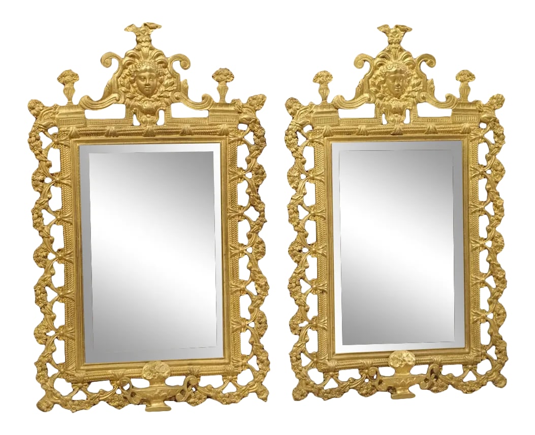 Antique French Bronze Dore Mirrors With Mascarons and Floral Motifs, Circa 1880 - a Pair: This pair of small bronze dore mirrors are from France, circa 1880, and were made in the style of Louis XIV. The intricate bronze dore frames have a large cartouche at the top of the frame that