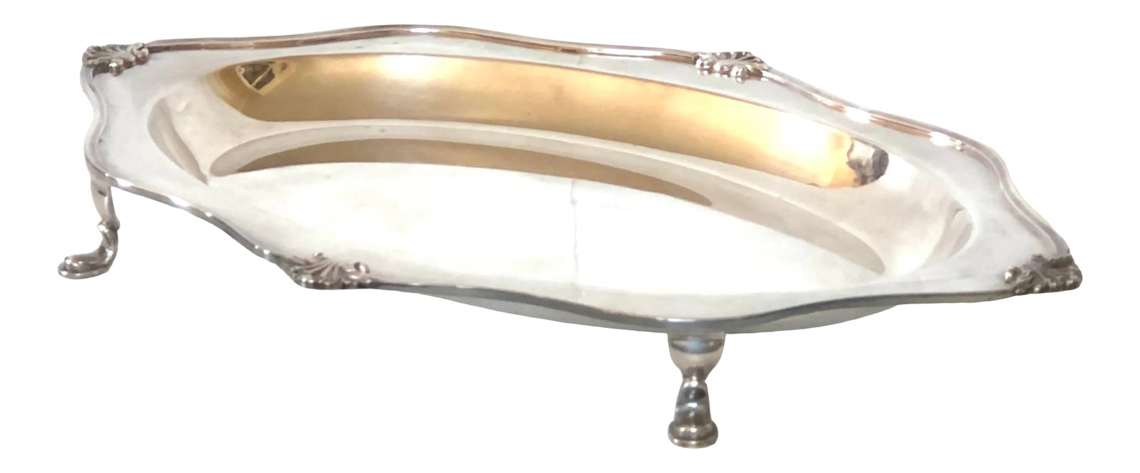 1940s Sheffield Silver Footed Serving Tray: Sheffield silverplate serving tray with pad feet. Shell motif along curved piped edges and deep well to hold sauces. A perfect size for resting those greasy serving spoons to protect your fine linen