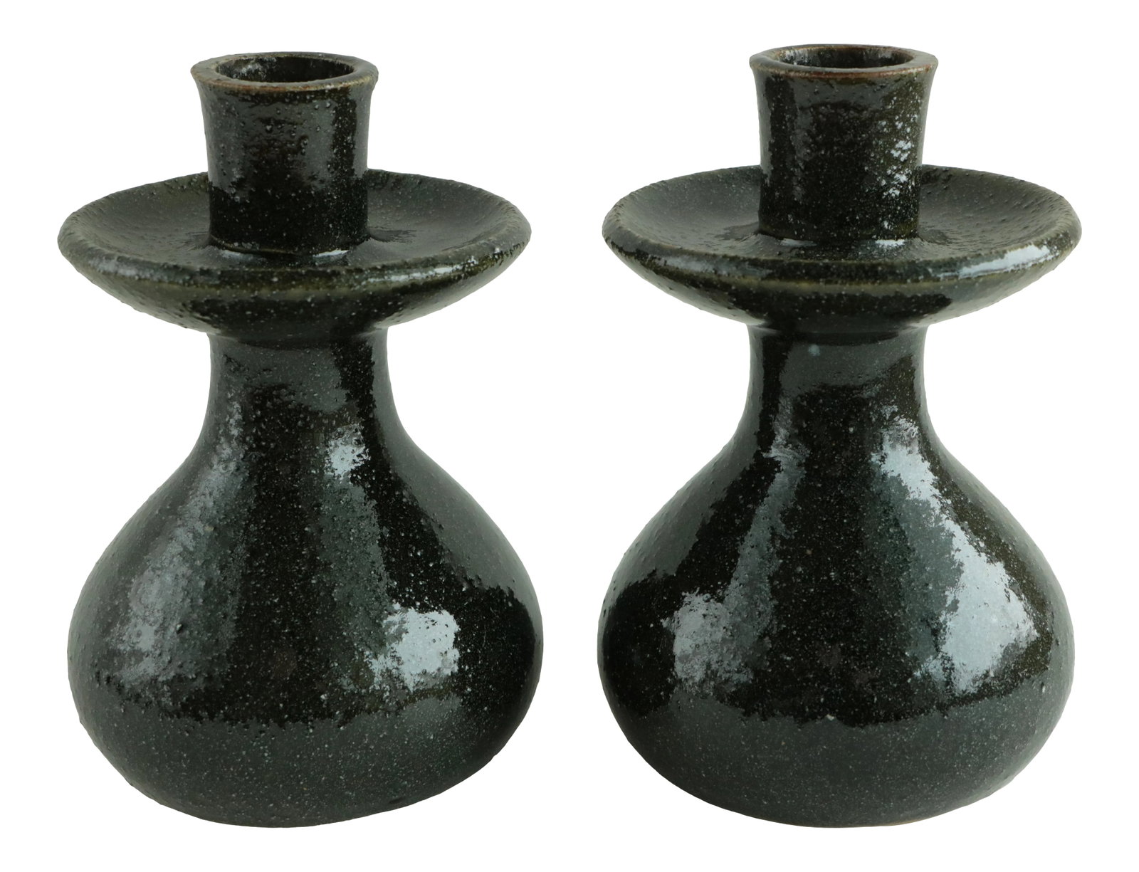 Mid-Century Pottery Candlestick Holders - a Pair: This pair of vintage candleholders has a deep green "avocado peel" textured glaze. Their bulbous shape and integrated drip-catchers make them stable, functional, and a beautiful addition to your mid-c