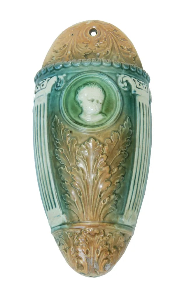1910s Roseville Cameo Ceramic Wall Pocket: Add a distinctive touch to your wall decor with this rare wall pocket in the classic Cameo pattern by Roseville. This wonderful antique piece is decorated with an adorable cherub cameo, classic doric