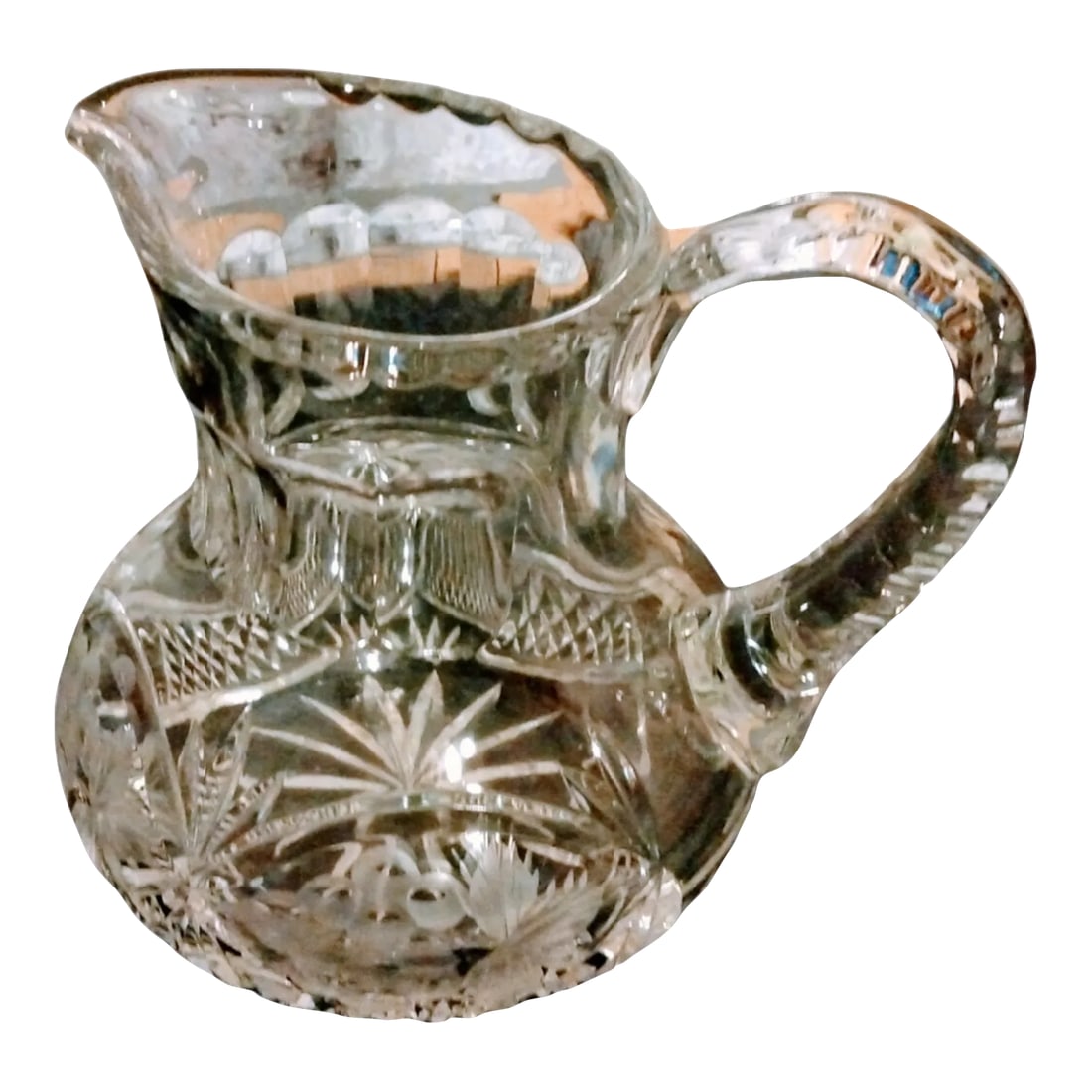 Vintage Crystal Water Pitcher: Small heavy Chrystal water pitcher. I'm not sure if it is an American Brilliant or vintage Polish Crystal? (I'm leaning towards the Polish Crystal, but am not an expert) The beautiful pitcher stands