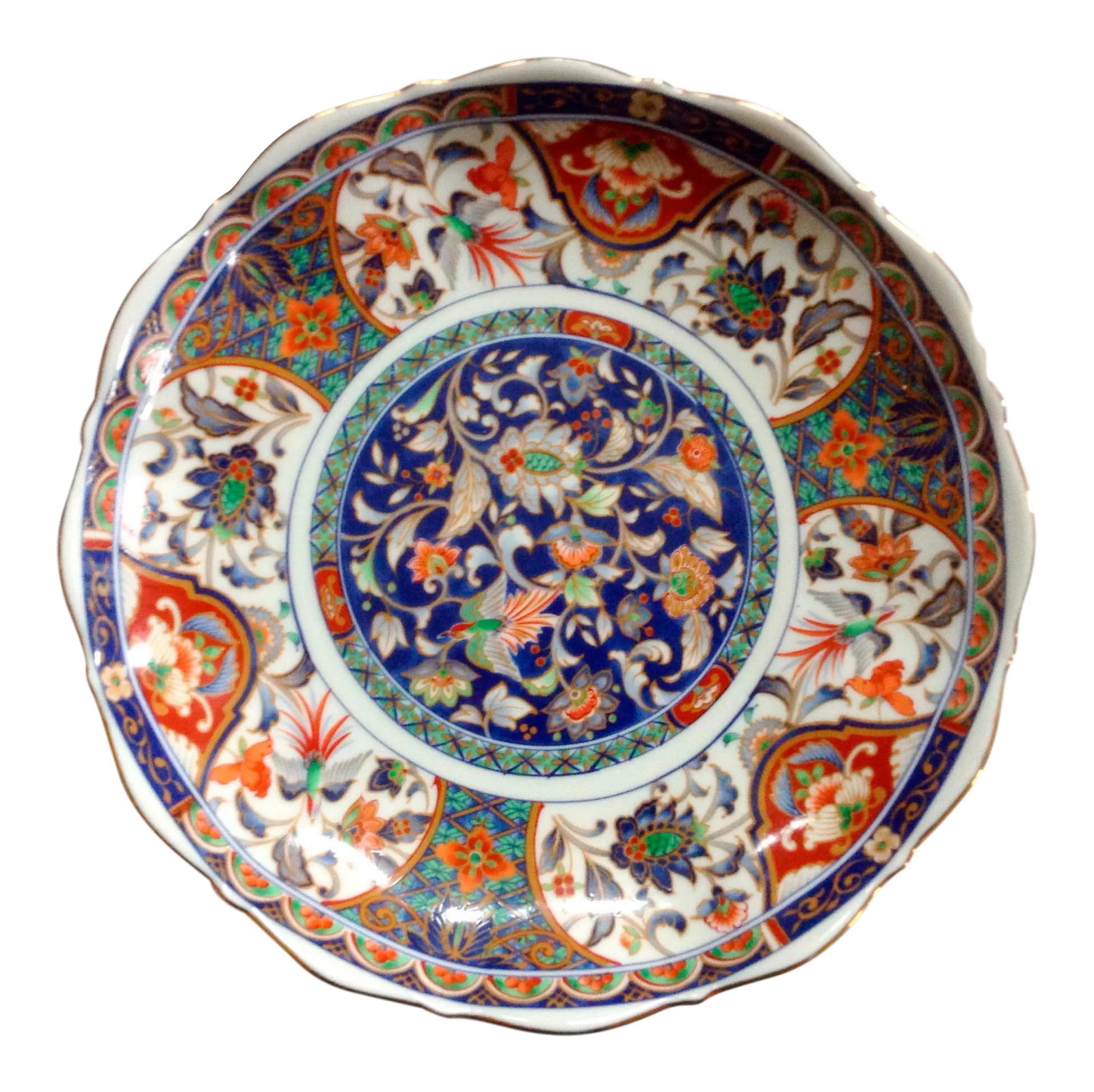 Asian Raised Imari Serving Plate: Beautiful Imari server is decorated throughout with a floral and bird pattern. Plate has a ruffled edge and is tucked around with a raised decorated base. Maker's mark on the bottom. Condition: