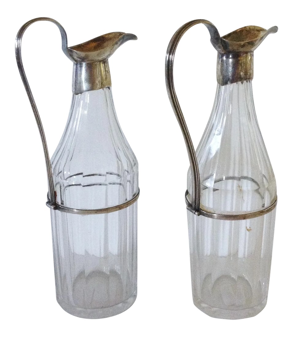Georgian Cruets - a Pair: This beautiful pair of Georgian English cruets are heavy fluted glass that is circled in a sterling silver band fashioned up with an elegant handle that is attached to the top pouring spout. The